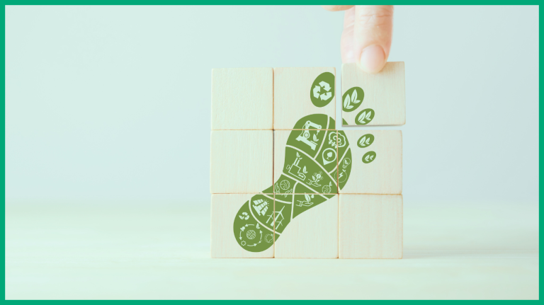 Green carbon footprint with symbols in the middle showcasing the carbon problems with a finger pointing towards it